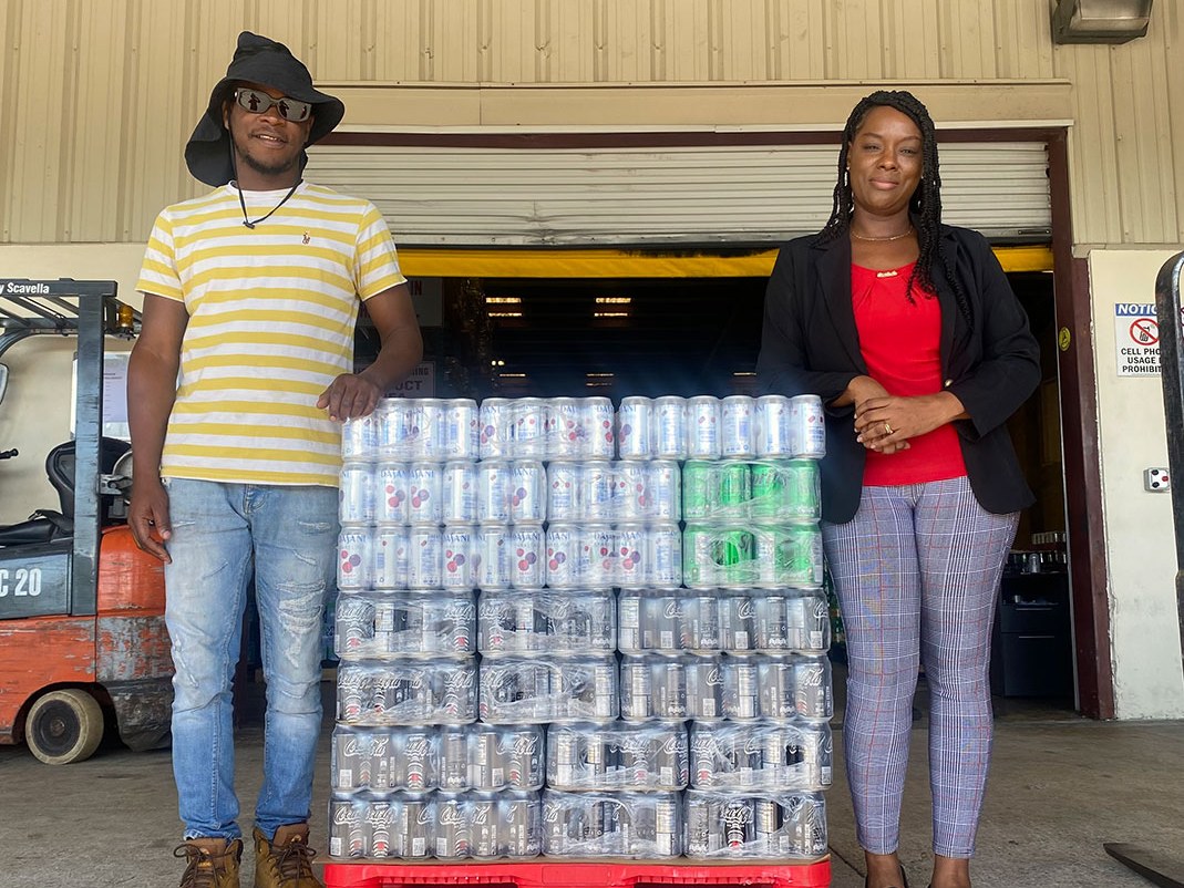 Caribbean Bottling Company warehouse staff with a pallet of product